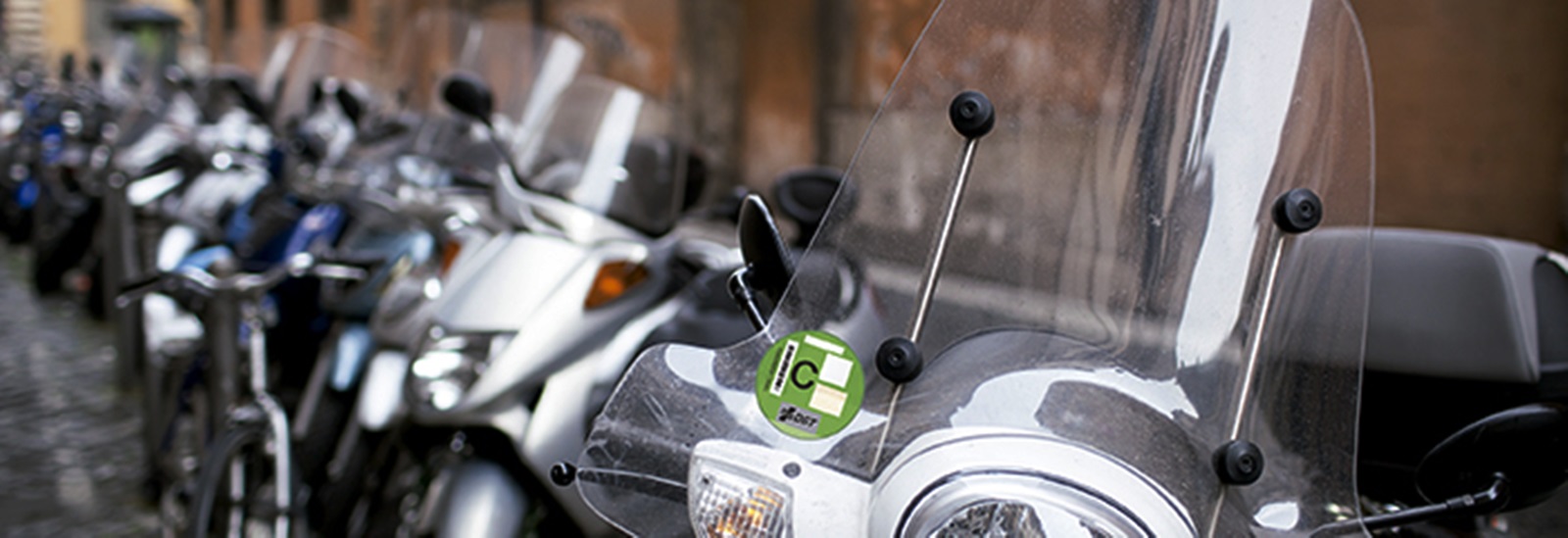 Row Of Motorbikes And Scooters Parked In One Of The Ancient Stre